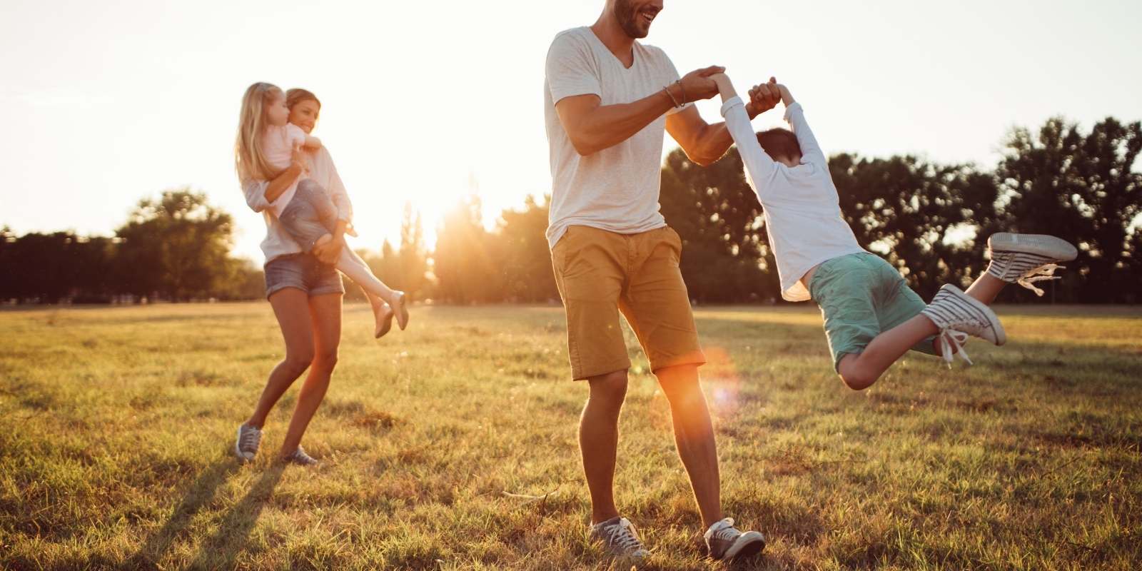 Family plays together man lifts child